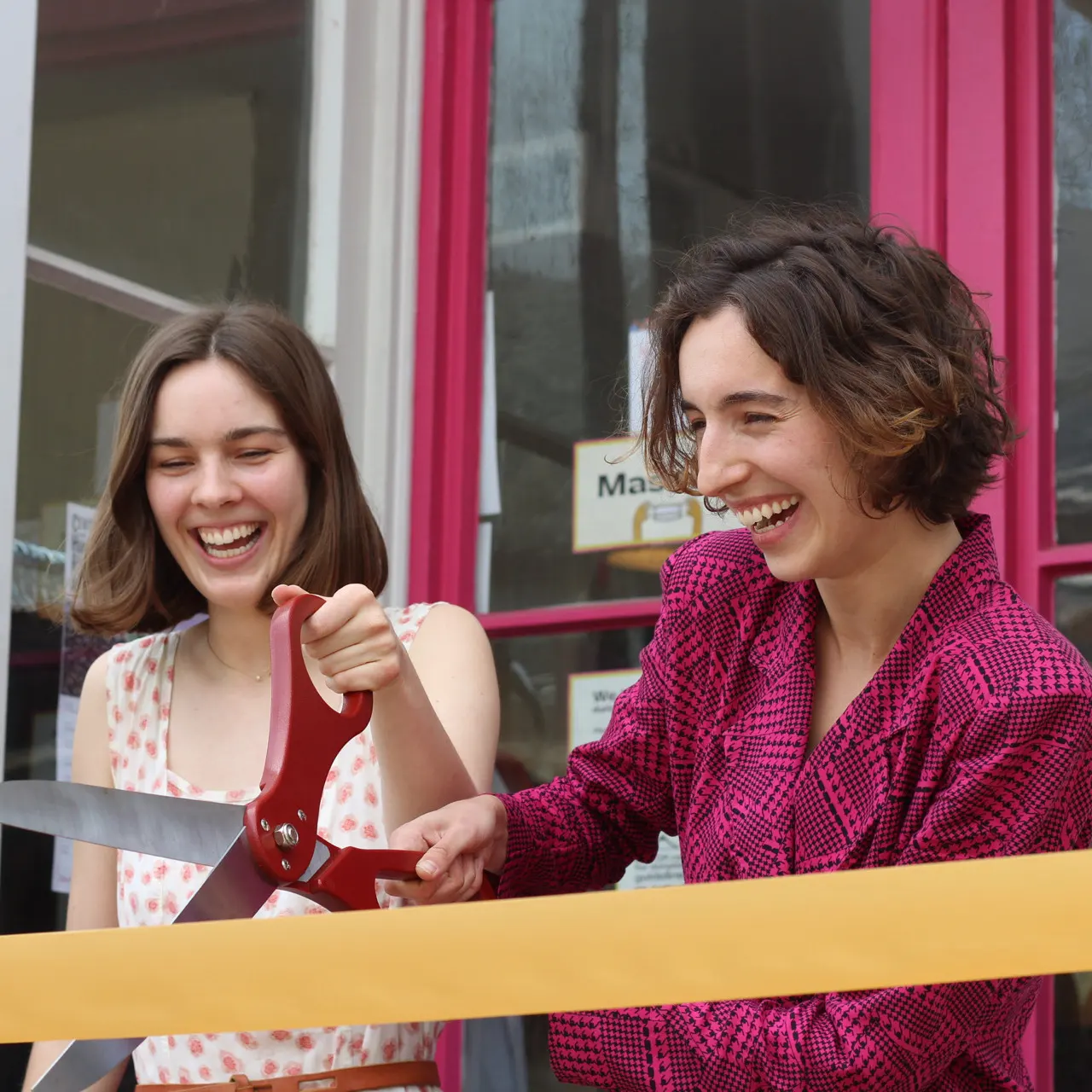 Jillian and Masha cutting the ribbon at the grand opening